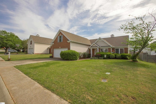 view of front of house featuring driveway, brick siding, fence, a garage, and a front yard