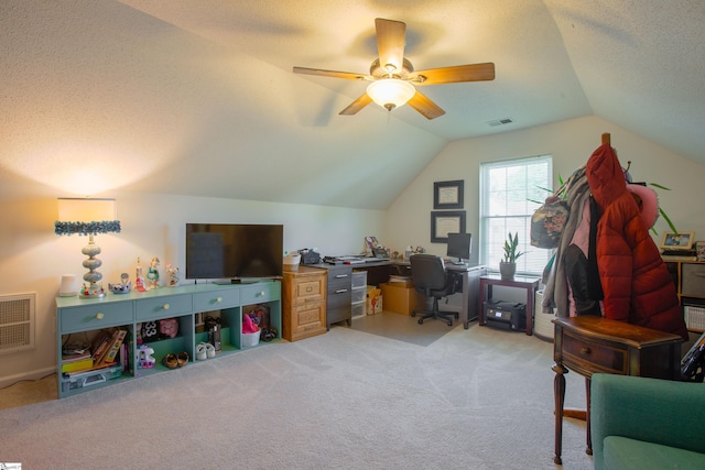office space featuring carpet floors, a textured ceiling, visible vents, ceiling fan, and vaulted ceiling