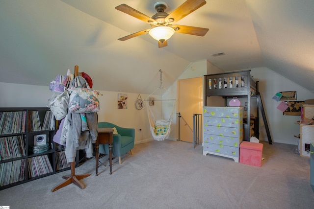 interior space featuring a ceiling fan, visible vents, and vaulted ceiling