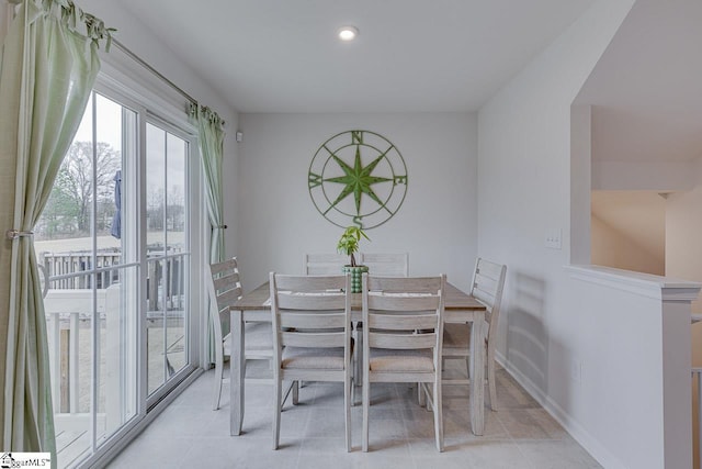 dining area with light tile patterned floors, baseboards, and recessed lighting