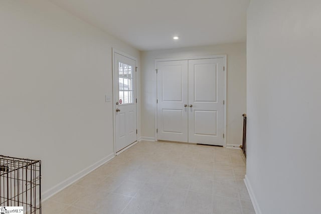 entrance foyer featuring baseboards and recessed lighting