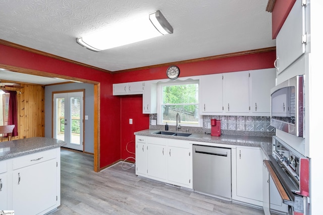 kitchen with a sink, white cabinetry, and appliances with stainless steel finishes