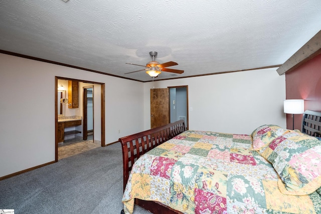 carpeted bedroom featuring crown molding, ensuite bathroom, baseboards, and ceiling fan
