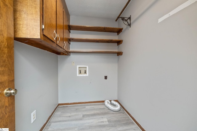 laundry area featuring wood finished floors, cabinet space, washer hookup, hookup for an electric dryer, and baseboards