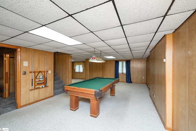 rec room featuring a paneled ceiling, wood walls, pool table, and baseboards