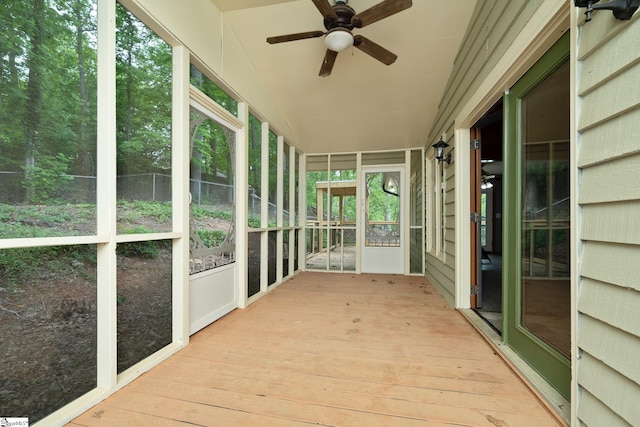 unfurnished sunroom featuring ceiling fan