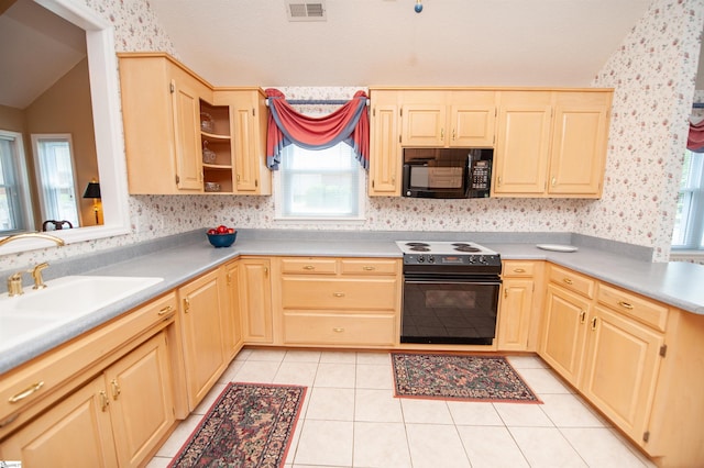 kitchen featuring wallpapered walls, plenty of natural light, visible vents, and black appliances