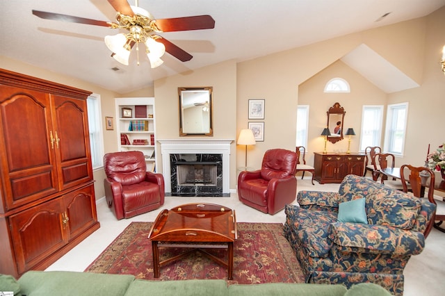 living room with a ceiling fan, baseboards, lofted ceiling, and a high end fireplace