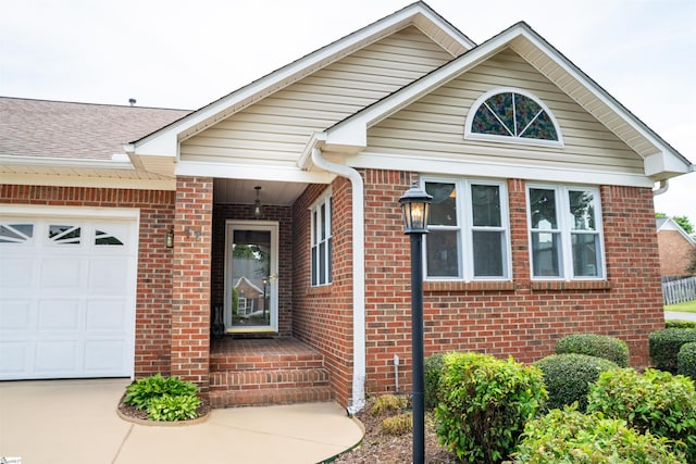 view of front facade with concrete driveway, brick siding, and a garage