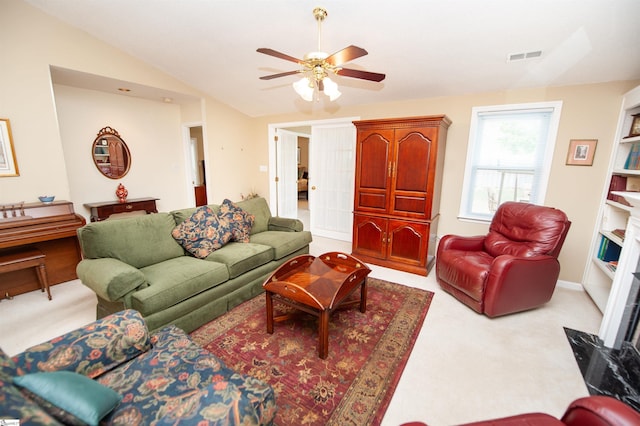 living room with a ceiling fan, carpet flooring, visible vents, and lofted ceiling