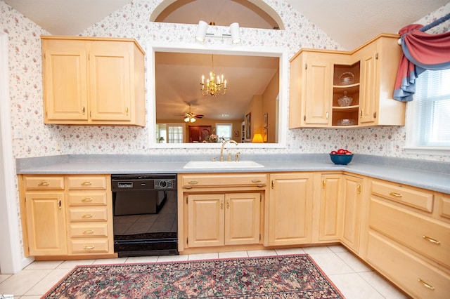 kitchen with lofted ceiling, black dishwasher, light tile patterned floors, and a sink
