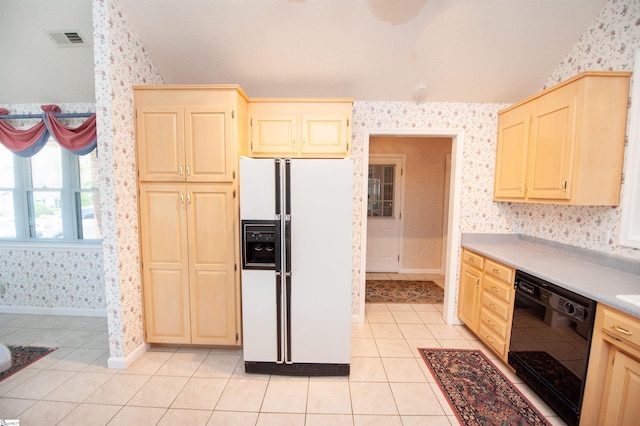 kitchen featuring lofted ceiling, white refrigerator with ice dispenser, wallpapered walls, and dishwasher
