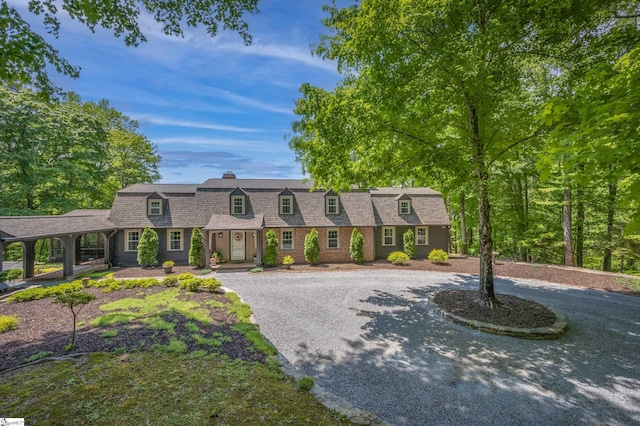 354 Jasmine Ln, Tryon, NC 28782 - view of front of home with a chimney, a gambrel roof, curved driveway, and a shingled roof