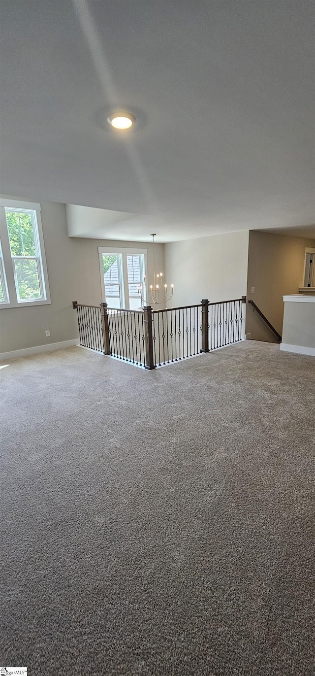 317 Breakwater Ln, Seneca, SC 29678 - empty room featuring a chandelier, plenty of natural light, carpet floors, and baseboards