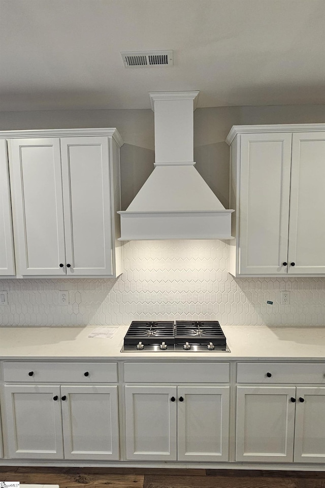317 Breakwater Ln, Seneca, SC 29678 - kitchen featuring custom exhaust hood, white cabinetry, tasteful backsplash, and stainless steel gas stovetop