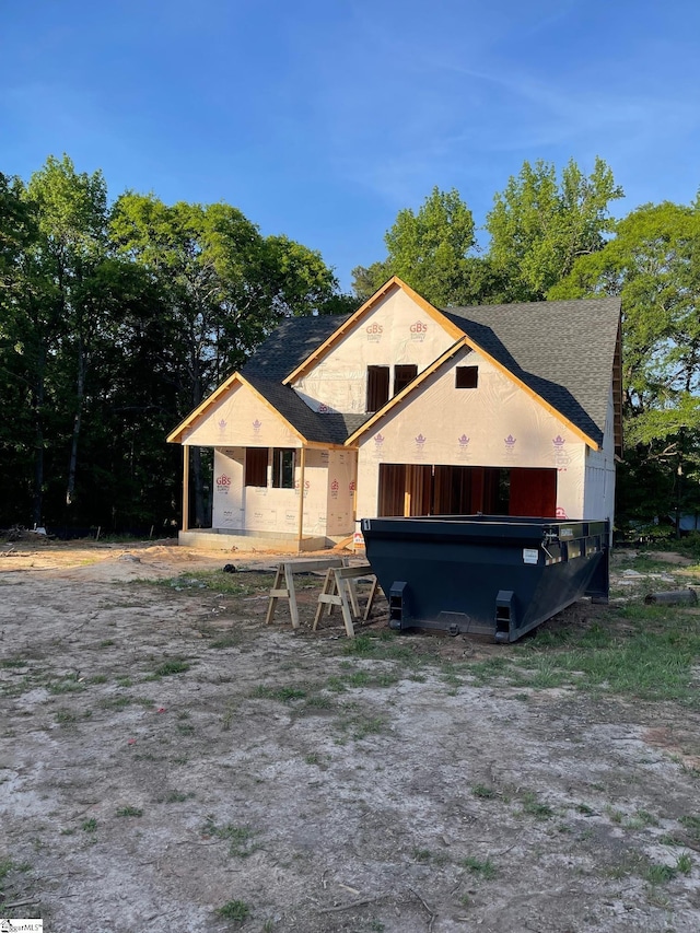 view of front of home with a shingled roof