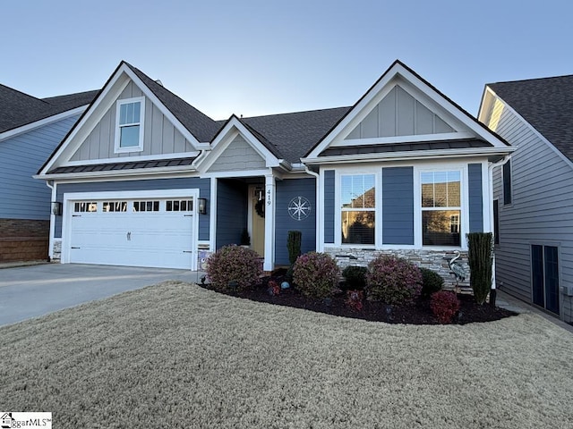 craftsman-style house with concrete driveway, board and batten siding, a standing seam roof, and stone siding