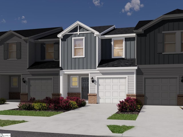view of front of home featuring an attached garage, board and batten siding, brick siding, and driveway