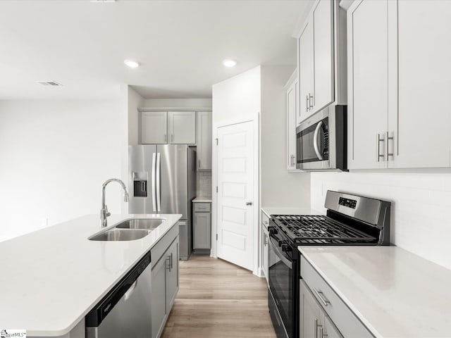 112 Arrow Ct, Greer, SC 29651 - kitchen with stainless steel appliances, recessed lighting, decorative backsplash, an island with sink, and light wood-type flooring