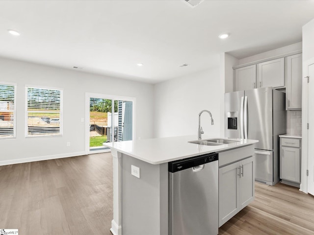 112 Arrow Ct, Greer, SC 29651 - kitchen featuring appliances with stainless steel finishes, light wood-type flooring, light countertops, a center island with sink, and recessed lighting