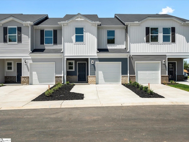112 Arrow Ct, Greer, SC 29651 - townhome / multi-family property featuring an attached garage, concrete driveway, board and batten siding, and brick siding