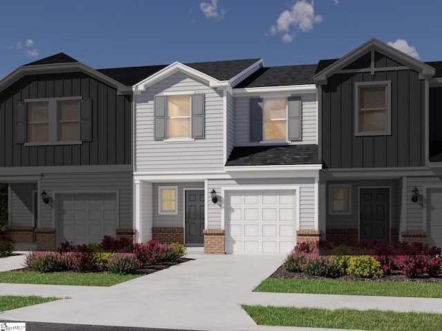 view of front of home with concrete driveway, board and batten siding, brick siding, and an attached garage
