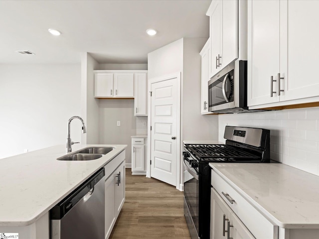 122 Arrow Ct, Greer, SC 29651 - kitchen featuring stainless steel appliances, backsplash, wood finished floors, white cabinetry, and recessed lighting