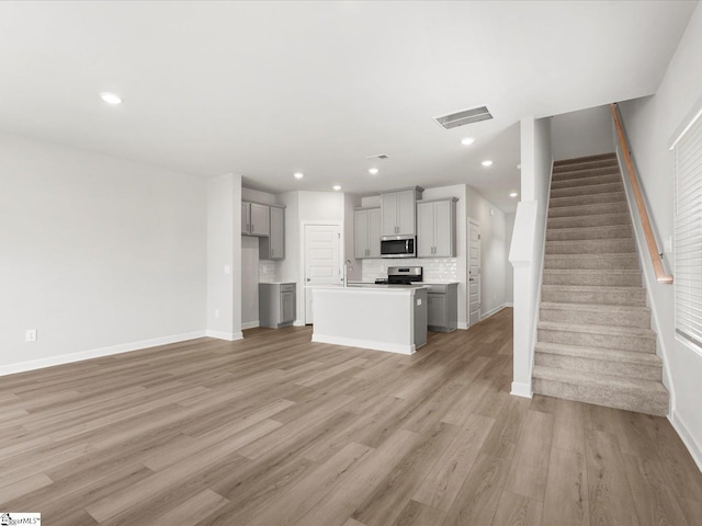 126 Arrow Ct, Greer, SC 29651 - unfurnished living room featuring light wood-style floors, stairway, and recessed lighting