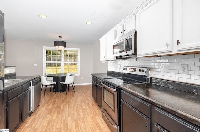301 Glenlea Ln, Greenville, SC 29617 - kitchen featuring light wood finished floors, white cabinets, dark countertops, and appliances with stainless steel finishes