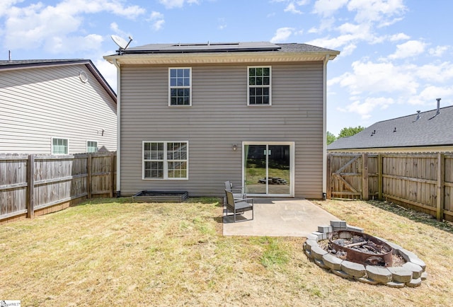301 Glenlea Ln, Greenville, SC 29617 - back of house featuring a fenced backyard, roof mounted solar panels, a patio, and a fire pit