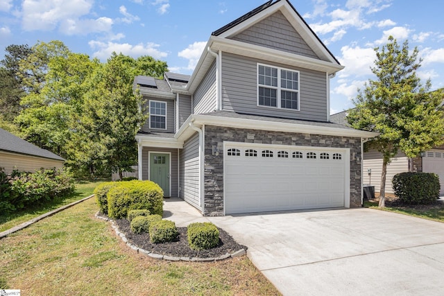 301 Glenlea Ln, Greenville, SC 29617 - traditional-style home with an attached garage, roof mounted solar panels, stone siding, concrete driveway, and a front yard