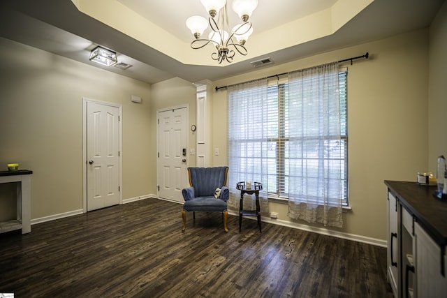 sitting room featuring baseboards, a notable chandelier, dark wood-type flooring, and visible vents