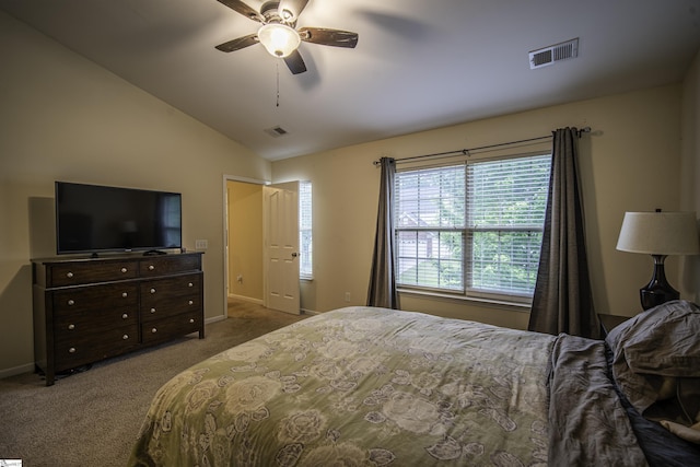 carpeted bedroom featuring vaulted ceiling, ceiling fan, baseboards, and visible vents