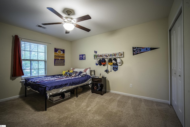 bedroom with baseboards, a closet, visible vents, and carpet floors