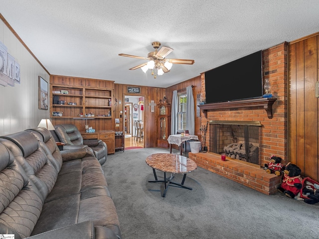 living area with a textured ceiling, wood walls, a ceiling fan, and carpet floors