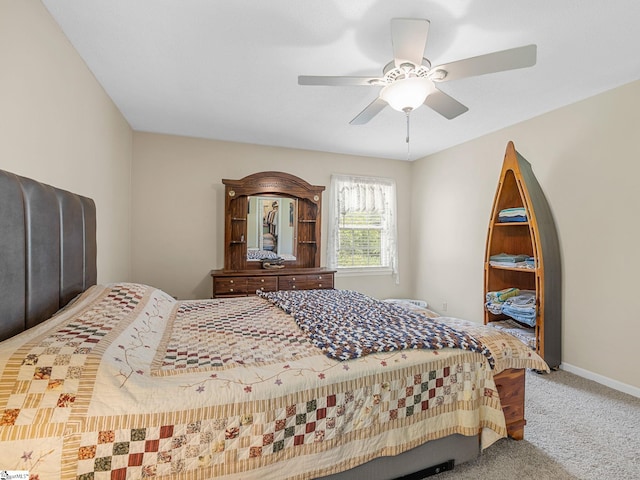 carpeted bedroom featuring baseboards and ceiling fan
