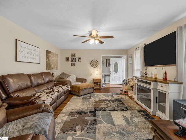 living room with wood finished floors and ceiling fan