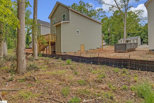 view of home's exterior featuring stairway, fence, and a wooden deck
