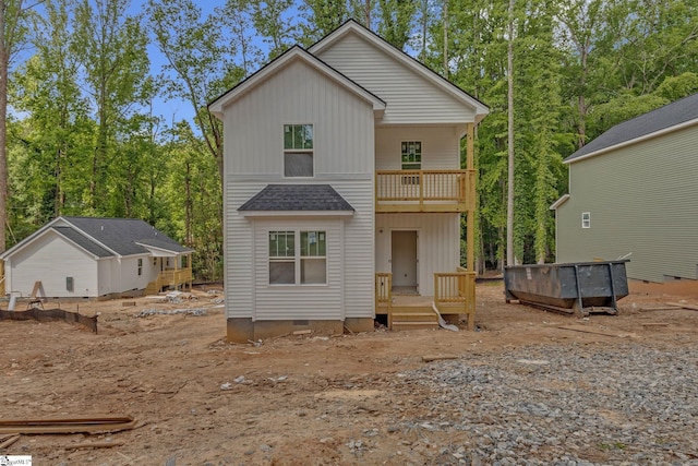 rear view of property featuring a balcony, board and batten siding, and crawl space