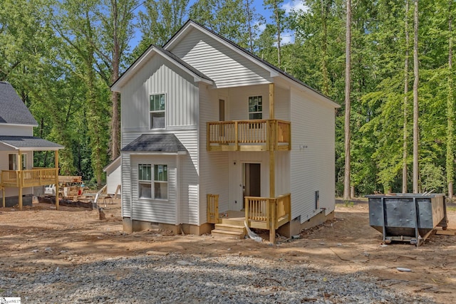 view of front of home featuring board and batten siding and a balcony
