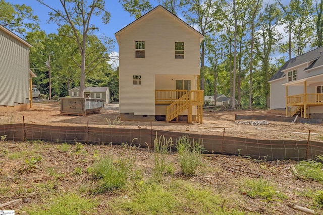 back of property featuring stairway, a deck, and crawl space