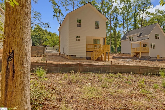 back of house with stairs, a wooden deck, fence, and crawl space