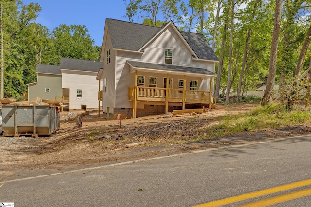 bungalow-style house featuring covered porch, a shingled roof, and crawl space