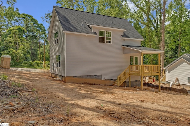 back of house featuring a shingled roof, crawl space, a wooden deck, and stairs
