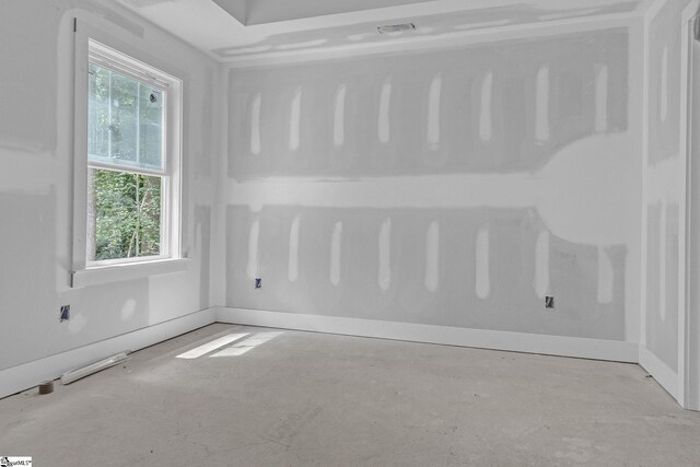 unfurnished room with unfinished concrete floors