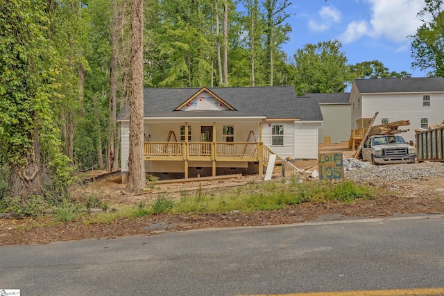 view of front of home with a porch, crawl space, and roof with shingles