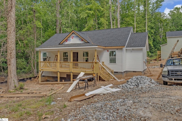 view of front of property featuring roof with shingles, stairs, a deck, and crawl space