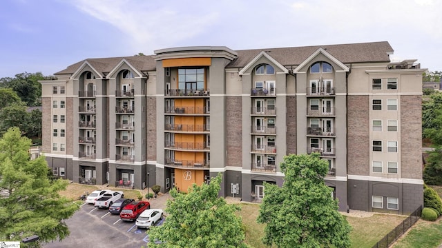 view of property featuring uncovered parking