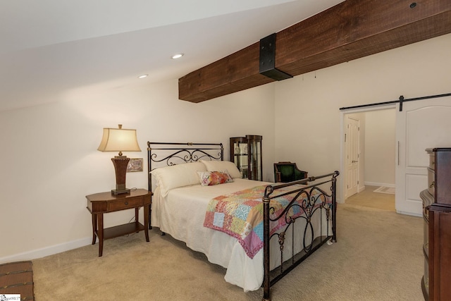 bedroom featuring light carpet, a barn door, and baseboards