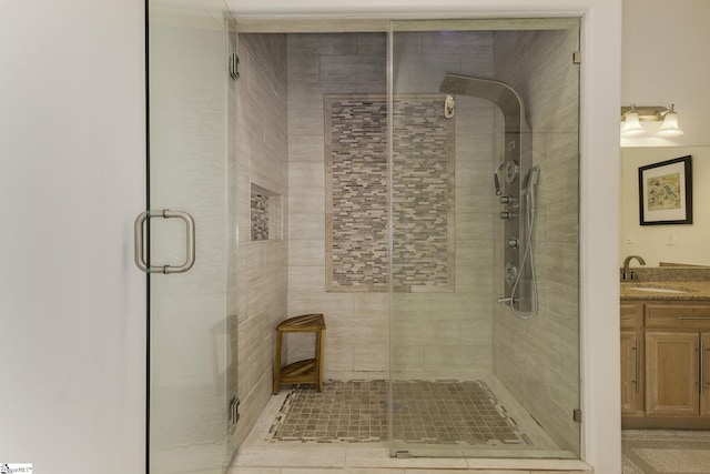 bathroom with vanity and a shower stall